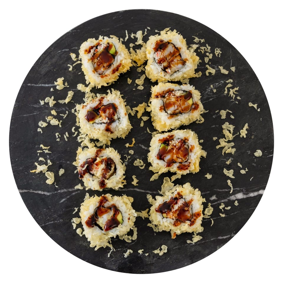 Eight pieces of Pisces sushi, deep-fried with a crispy coating and drizzled with dark sauce, on a black plate.